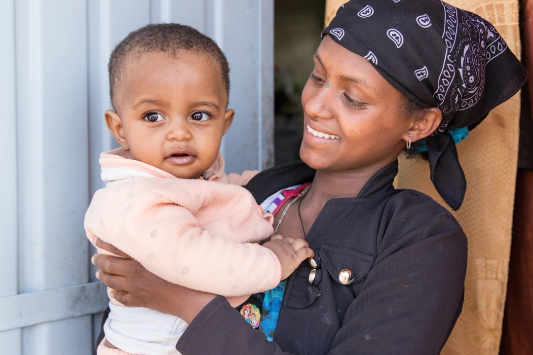 Smiling mother holding baby