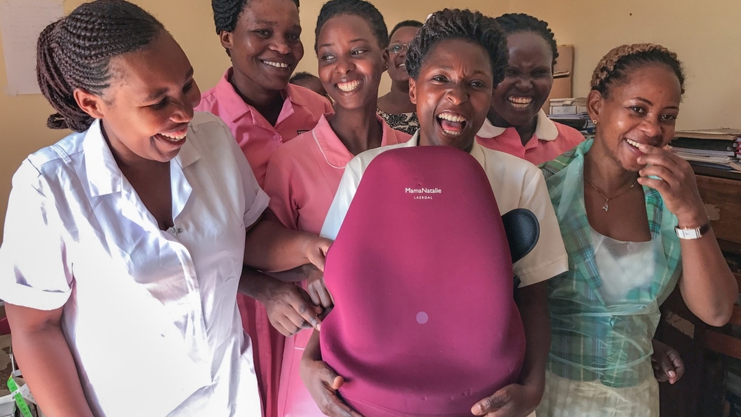 Group of midwives with birth simulator