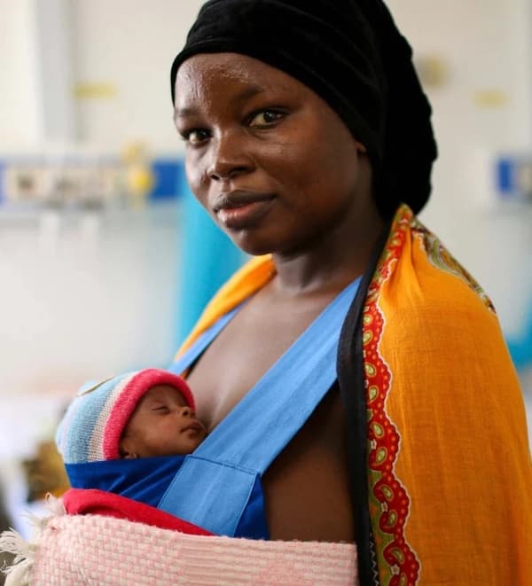 Woman holding baby skin to skin